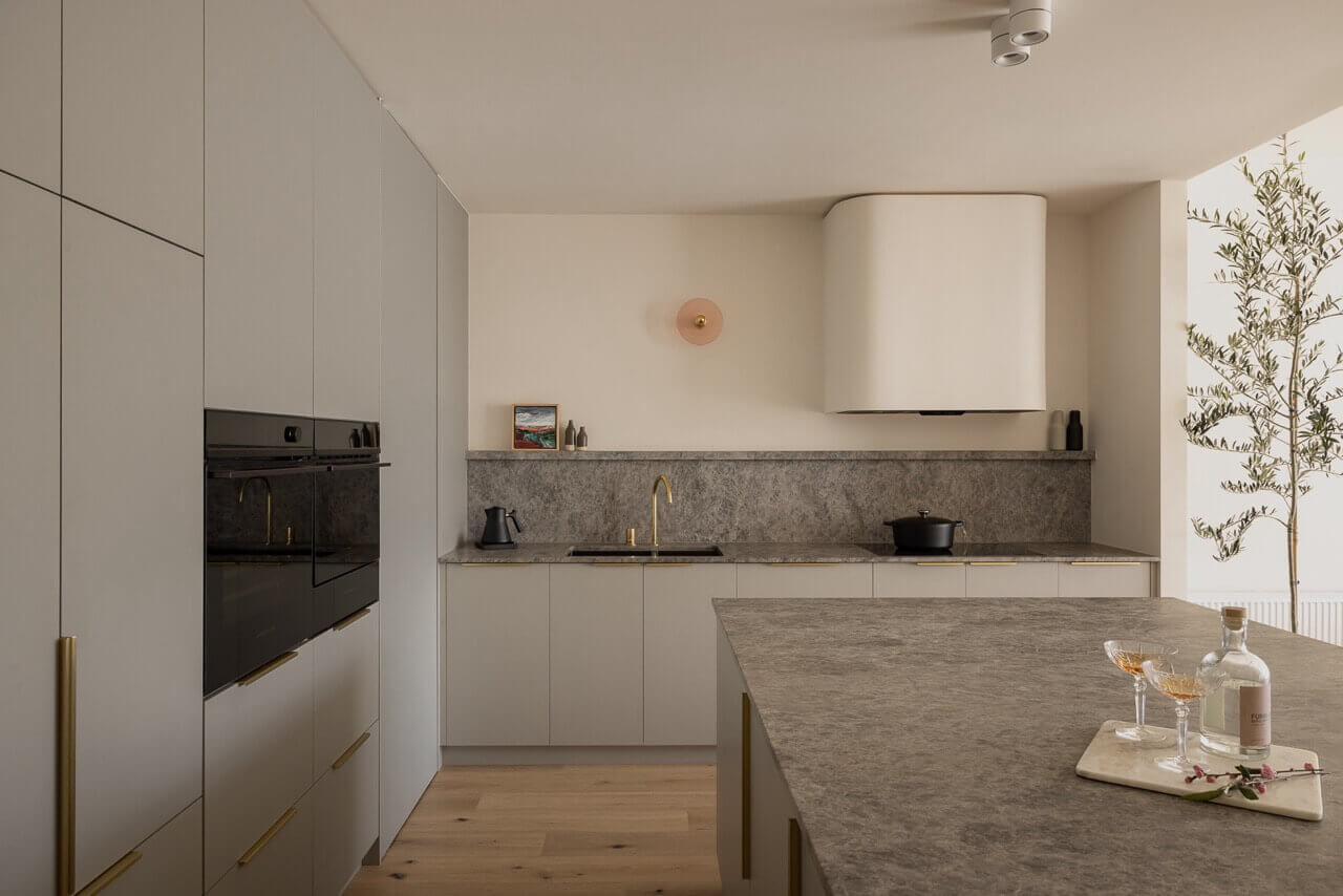 Elegant kitchen with marble countertop and wine rack, reflecting Furnishd's design aesthetic.