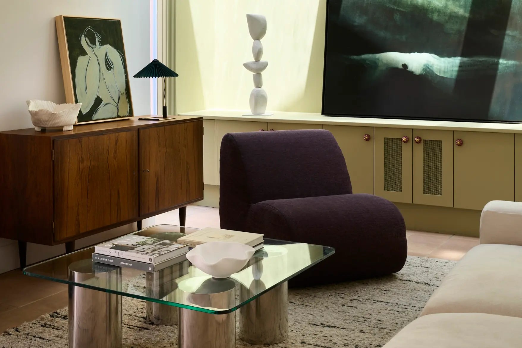 A spacious living room featuring a large painting on the wall, designed by FURNISHD.