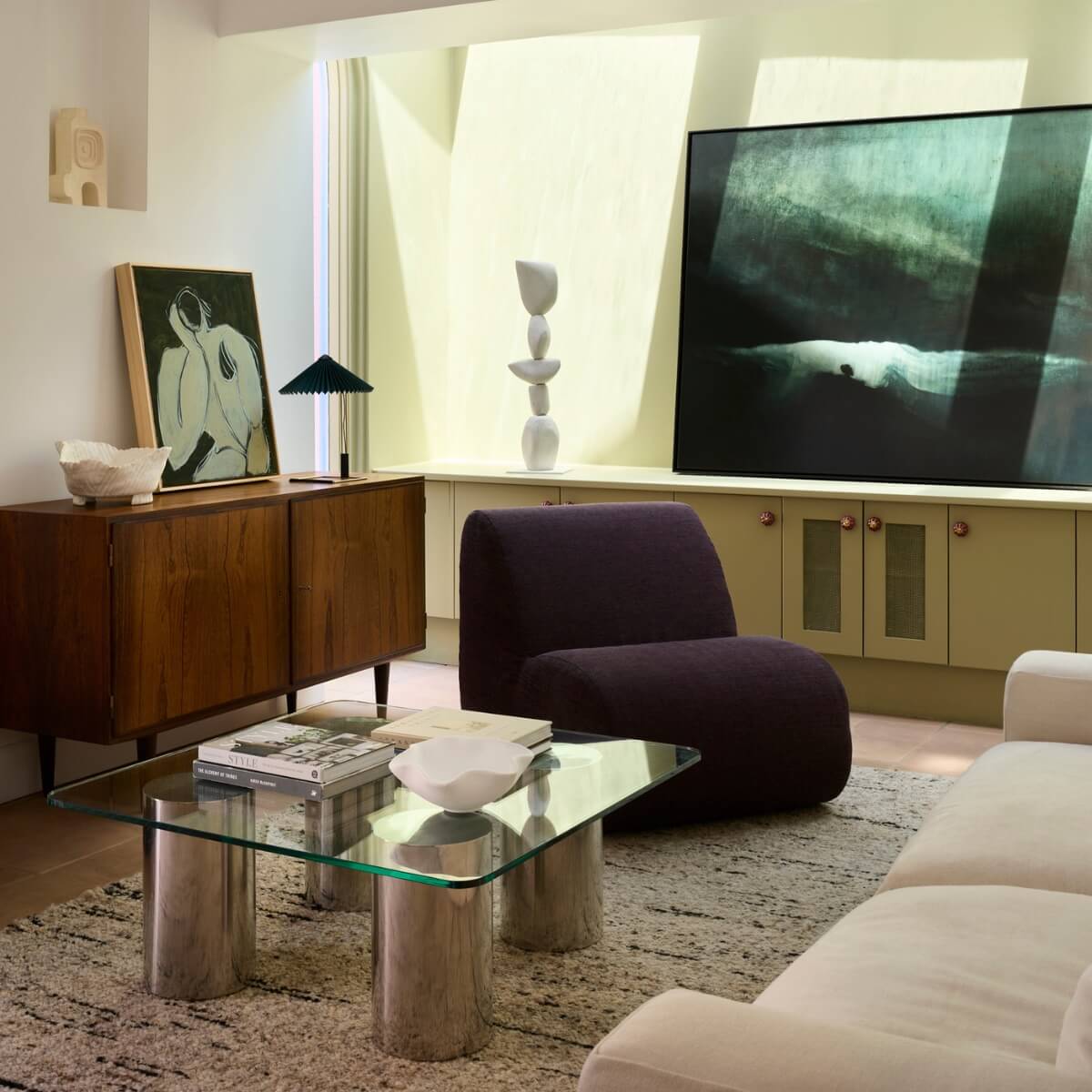 A stylish living room featuring a FURNISHD couch, coffee table, and a vibrant painting on the wall.