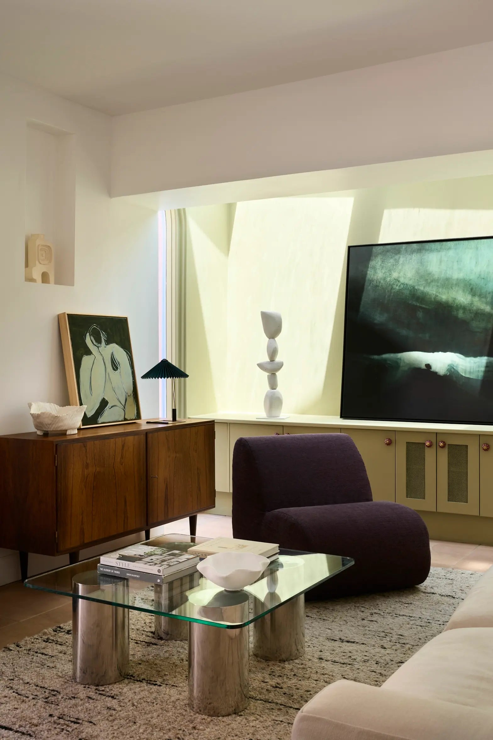 A stylish living room featuring a FURNISHD couch, coffee table, and a vibrant painting on the wall.